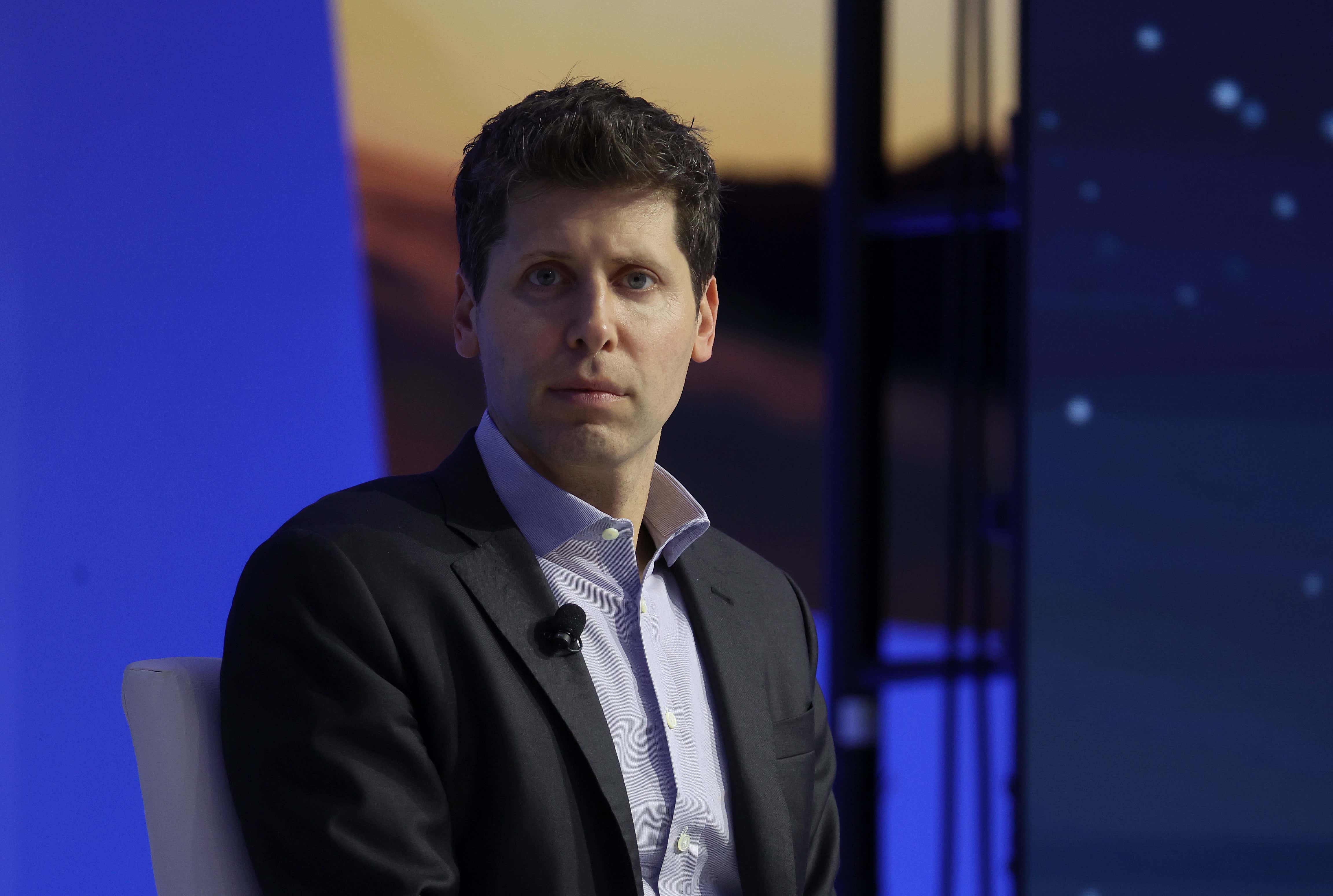 Sam Altman in a black suit jacket and blue button-down at the APEC CEO Summit